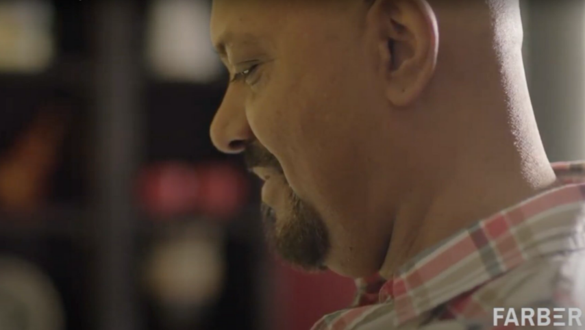 A man with a beard and mustache looking to his left.