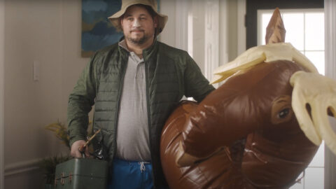 A man standing next to an inflatable toy.