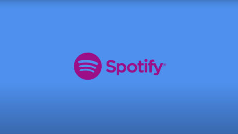 A blue background with the word spotify and an image of a pink logo.