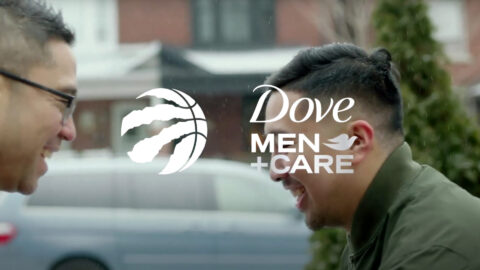 A man with a basketball on his ear and the logo for dove men + care.