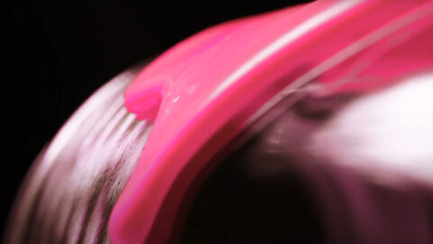 A close up of the pink paint on a glass