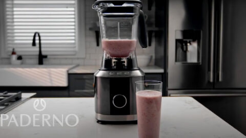 A blender with some pink liquid in it