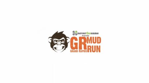 Logo for the grand rapids mud run featuring a stylized monkey face and the text "grand rapids mud run" in orange and brown colors.